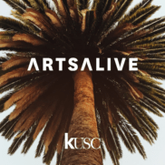 A photo of a palm tree outside, photographed from under the tree, with the text, "Arts Alive" and "KUSC" positioned in front of the tree. 